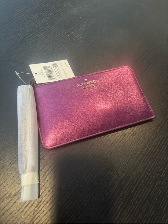 kate spade Handbags - kate spade metallic fuchsia zip-around wallet with gold logo